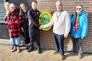 Mike Barker, Club President, Seaford Rotary handing over the AED cabinet to Finlay Crowe, Youth Chair, Seaford Town Football Club.  